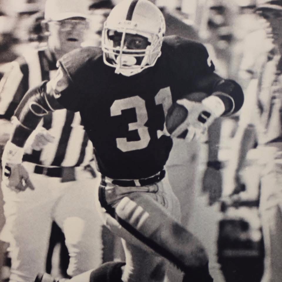 Craig Ellis running the ball in the Raiders number 31 jersey