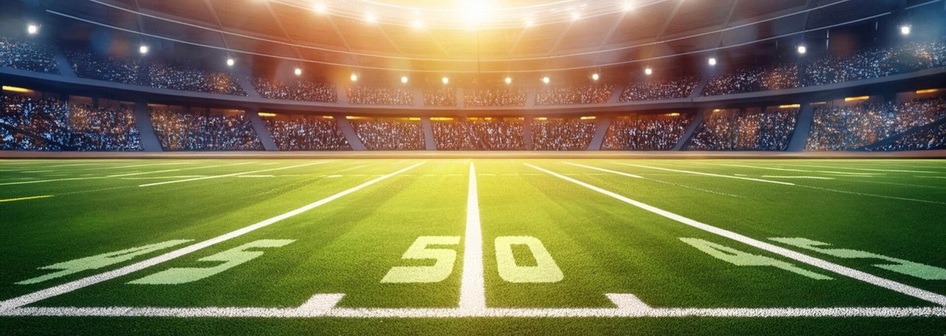 A floodlit football field seen from the fifty-yard line